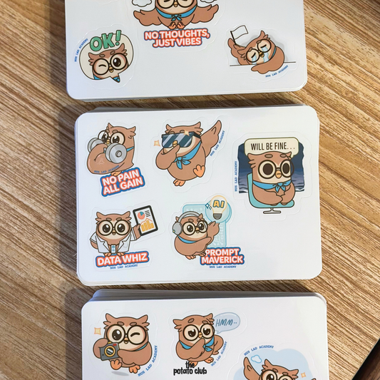 Three cards with cartoon owl characters on a wooden surface