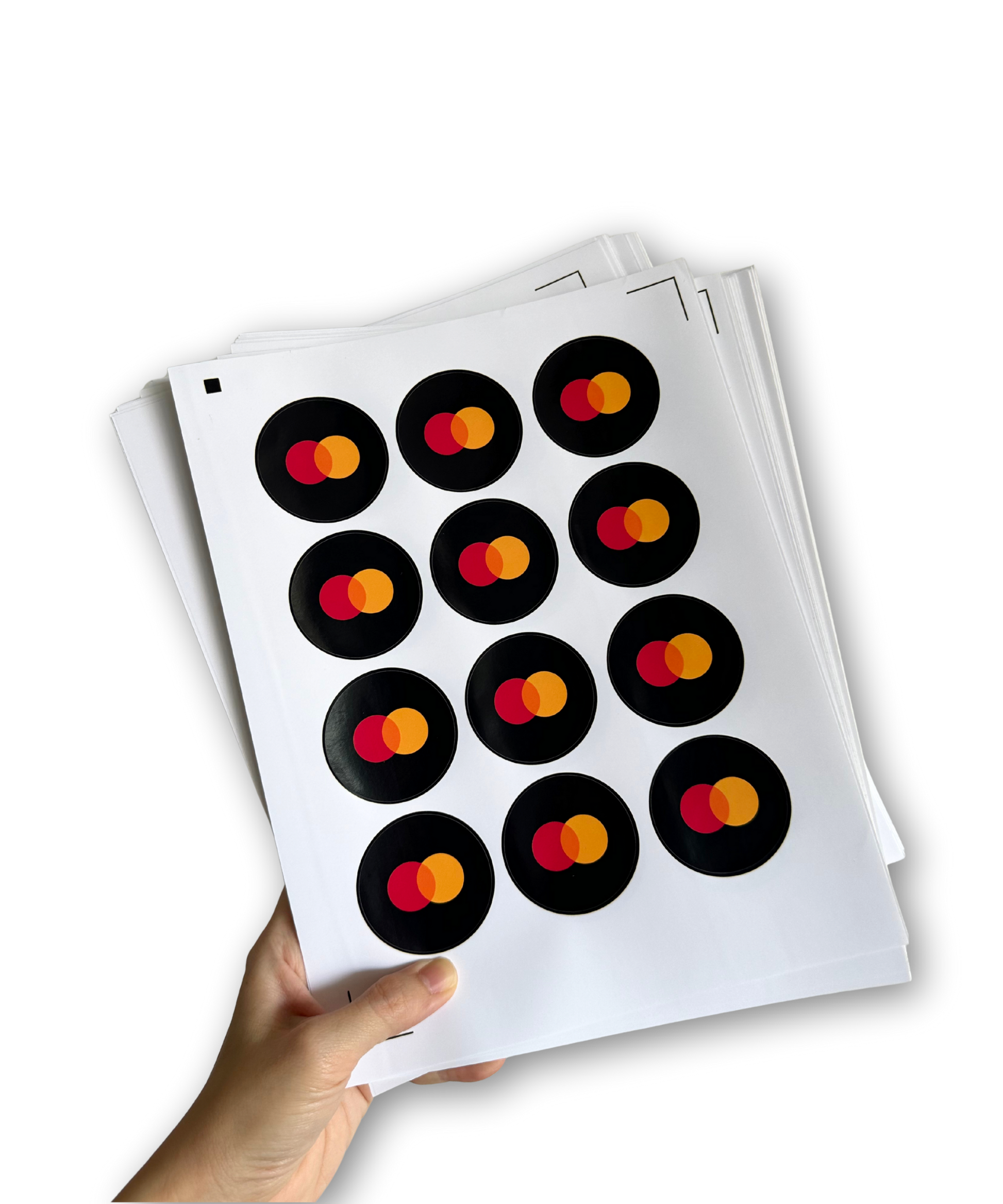 Sheet of Mastercard logo stickers held by a hand on a white background