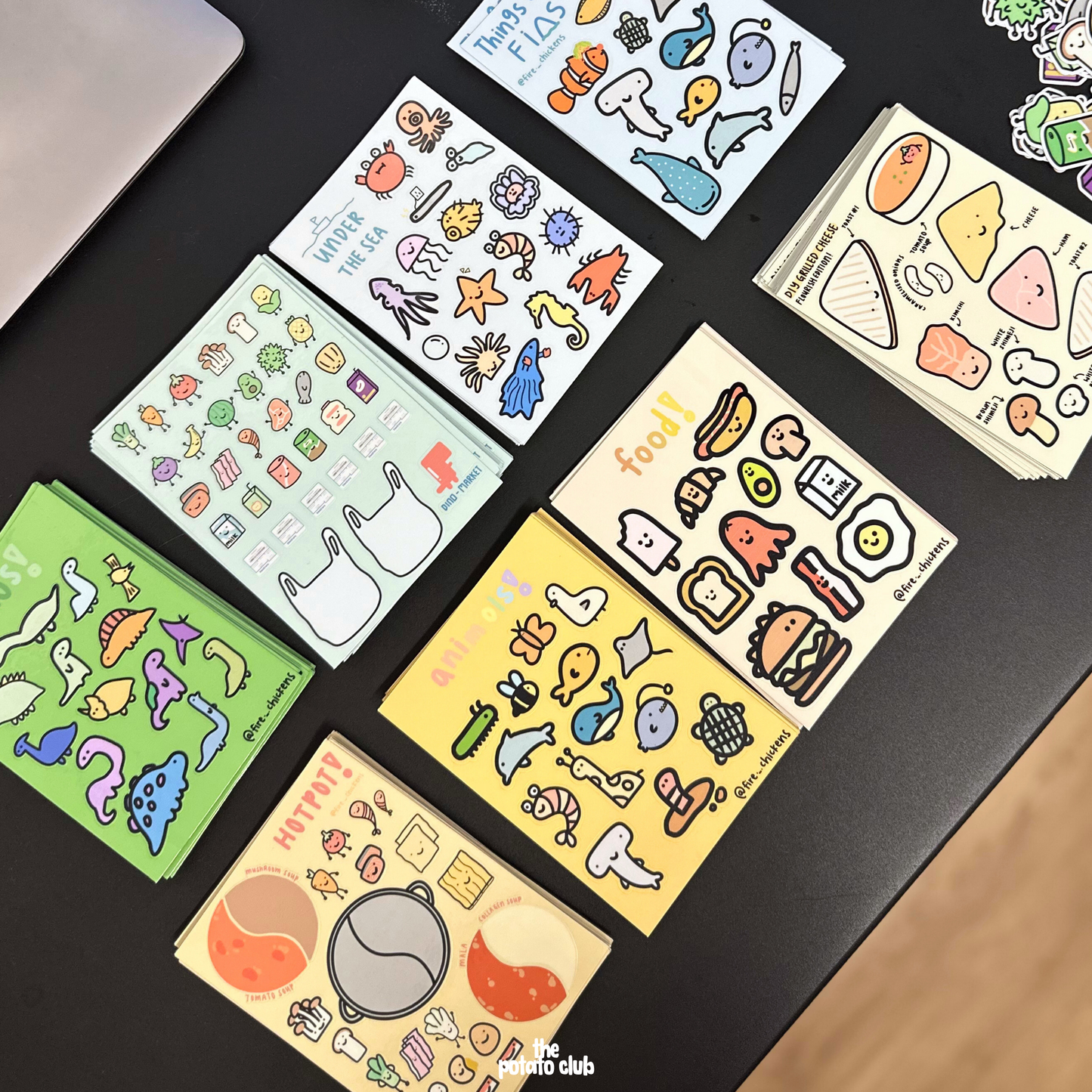 Collection of colorful sticker sheets on a dark surface