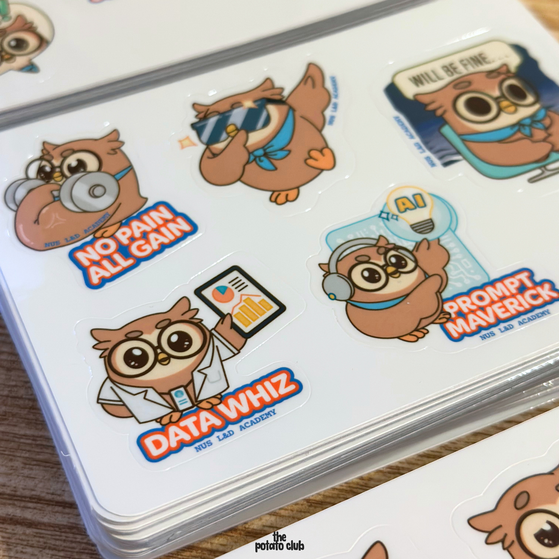 Set of custom sticker sheets with cartoon owl characters and text on a white surface.