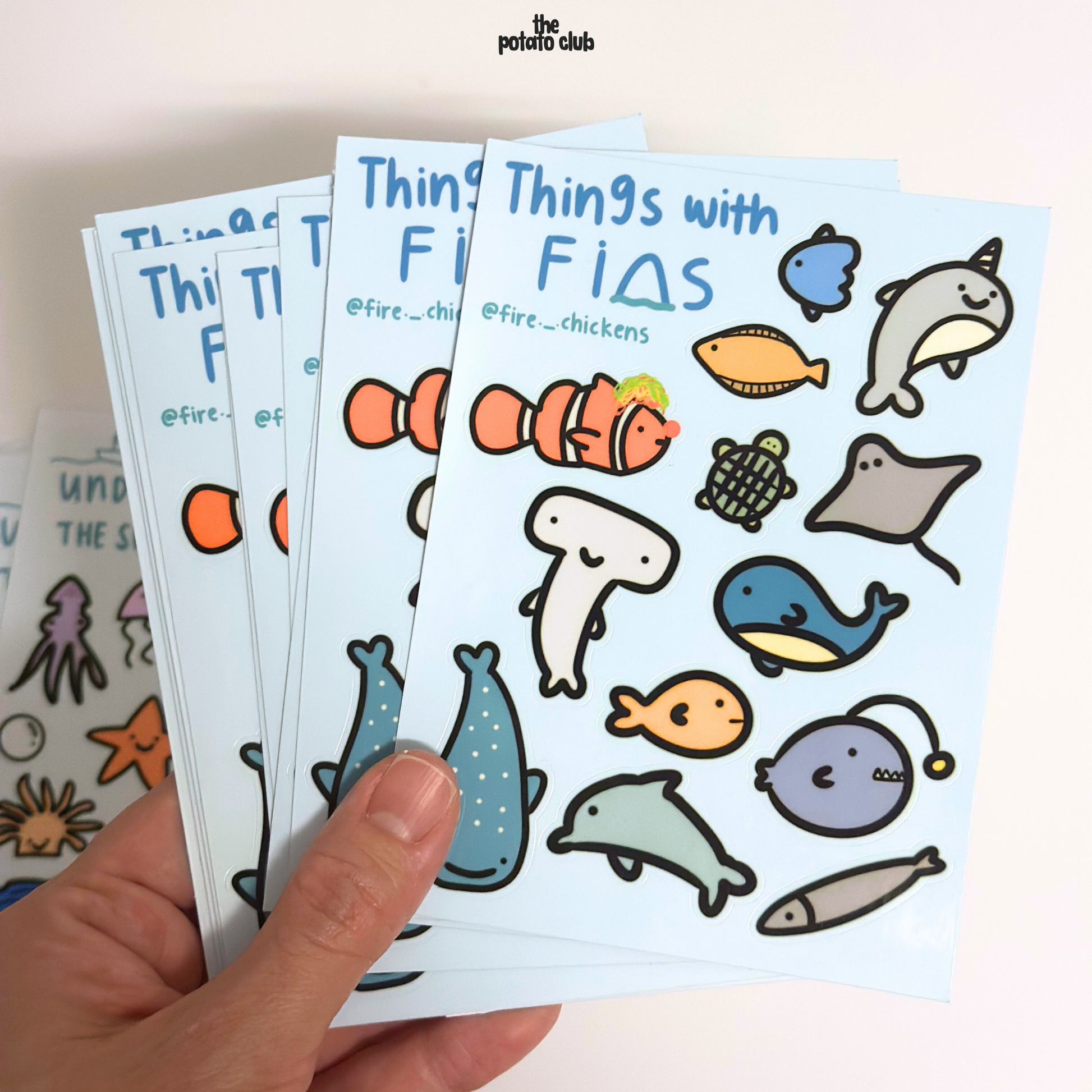 Sticker sheets with cartoon animals held by a hand, featuring the Potato Club branding.