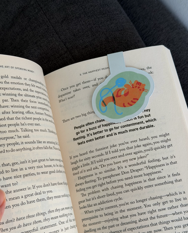 An open book spread showing printed text and a colorful circular diagram on the right page, photographed at an angle with a blurred background.