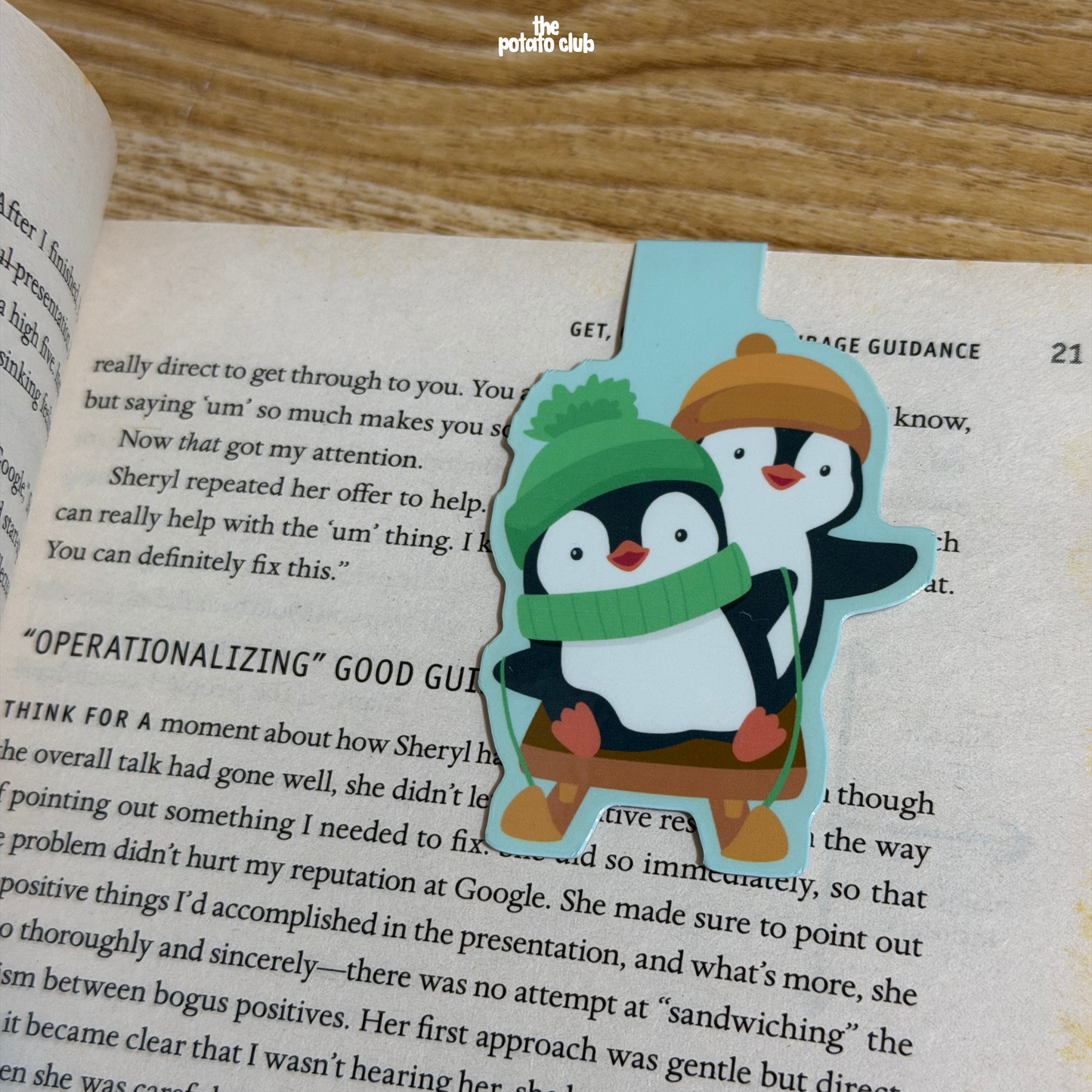 Book with a penguin bookmark on an open book